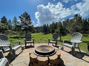 Fire pit in backyard overlooking golf course