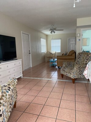 Large area with 2 recliners and king bed, there is also a large leather couch