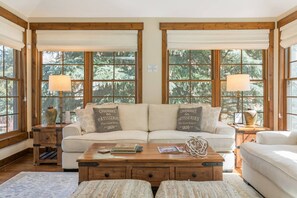 Living Room is wrapped in windows to allow you to soak up nature, or draw the blinds for privacy.