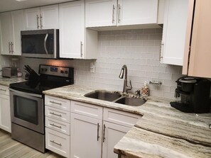 Bright , clean kitchen with stackable washer/ dryer 