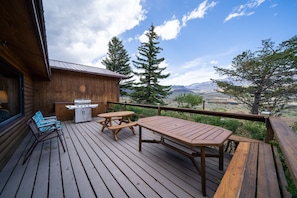 Deck with grill, seating, and mountain view