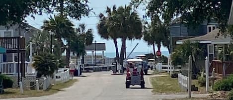 The main road going into the gated beach access. Home is in culdesac to the left