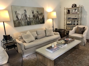 Living room with down sofa and large tv.