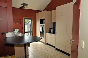 Open plan kitchen with dishwasher, wall oven and integrated fridge
