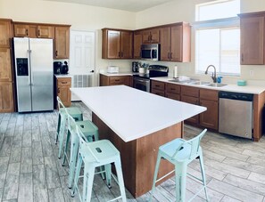 Kitchen with island seating, electric stove