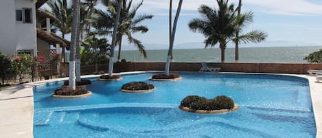 Community shared pool at Villas de Playa Condominium.