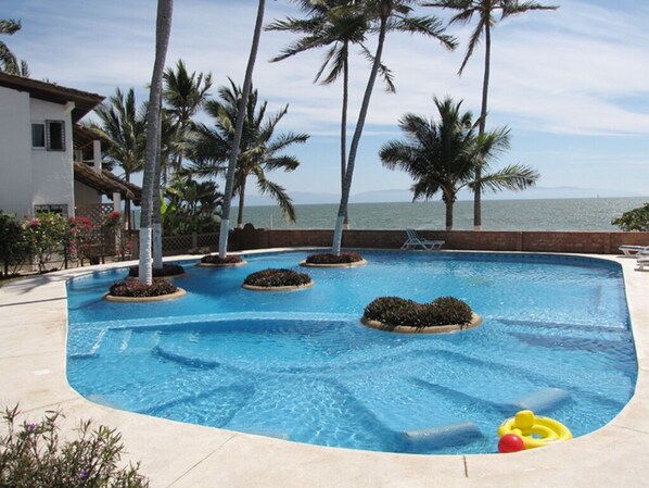 Community shared pool at Villas de Playa Condominium.
