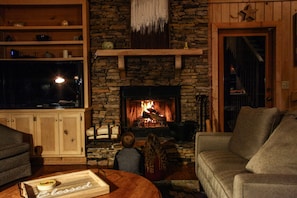 The fireplace attracts family member both young, and young at heart.