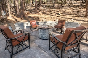 Beautiful back yard sitting area with fire pit private yard surrounded by pines