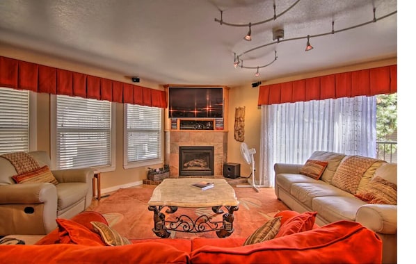 Large, cozy living room with a Smart TV, gas fireplace, and deck.