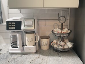 FlexBrew stocked with coffee filters/ground/pods, creamer and sugar
