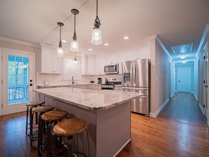 Eat in kitchen w/ breakfast bar and a cozy screened in porch just off the back