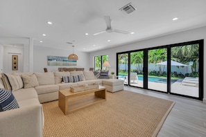 The ample living area overlooking the tropical garden which features a heated pool.