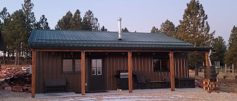 Bison Pines Cabin with 8' deep porch to enjoy grilling, sunsets, and wildlife. 