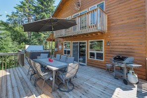 Outdoor Deck overlooking the yard and river with seasonal outdoor furniture