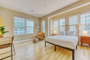 Well lit master bedroom with tall windows