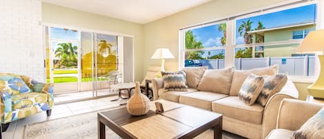 Large bright living area with oversized comfy couches.
