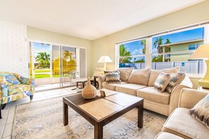 Large bright living area with oversized comfy couches.
