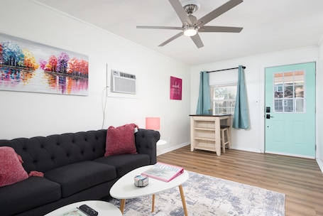 Living Room with comfy seating, an eating area and large Roku TV