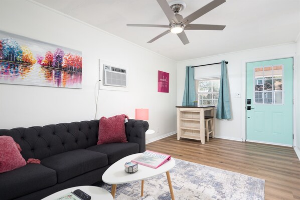 Living Room with comfy seating, an eating area and large Roku TV