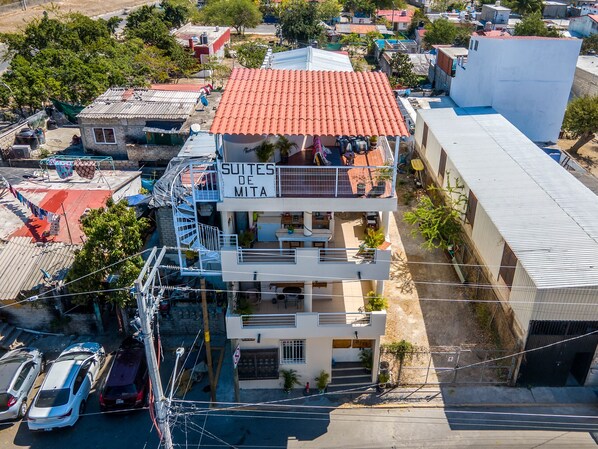 Birds eye view of Suites de Mita-Boutique Hotel with 3 common area balconies .