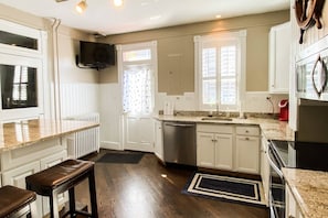 Enter into the bright kitchen from the two parking spots