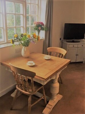 Beautiful sitting room with TV, table and chairs, Wi-fi, sofa and armchair, selection of bard games