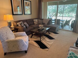 Section couch with chaise end and separate reclining chair.