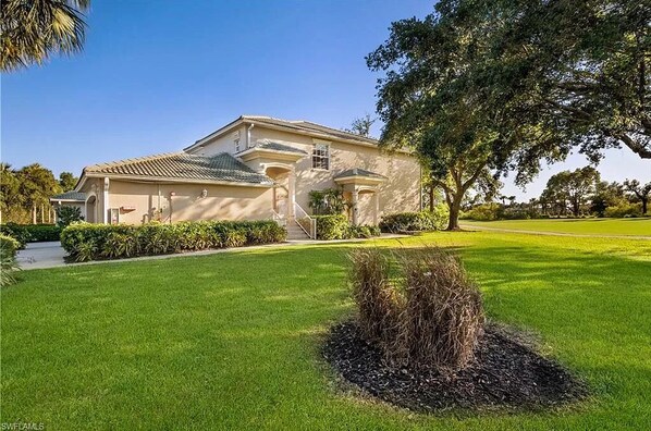 Front door, end unit, side view with large grass area
