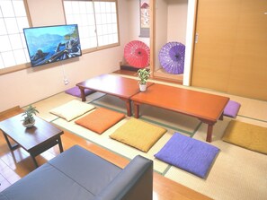 The living/dining room and bedroom on the first floor. A 50-inch TV is available, along with Netflix and Amazon Prime.