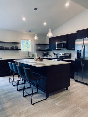 Fully stocked kitchen with island and bar seating