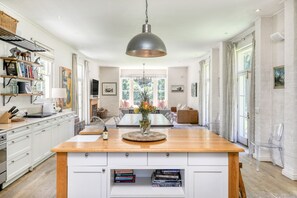 Open plan kitchen into dining and living areas.