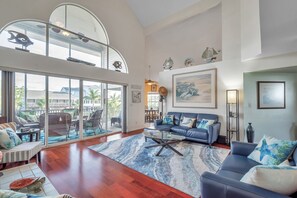 Living room with 20 foot ceilings and double sliders leading to the balcony!