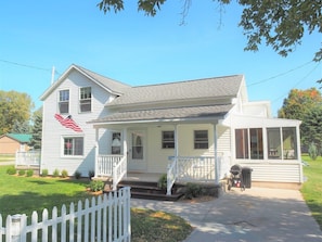 EXTERIOR: The driveway and front porch in summer.