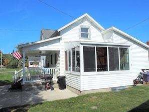 EXTERIOR: The south side of the house in summer.