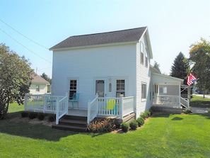 EXTERIOR: The side porch in summer.