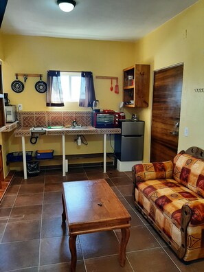 Full kitchen, dining, lounging areas, window view to ocean, fridge/freezer