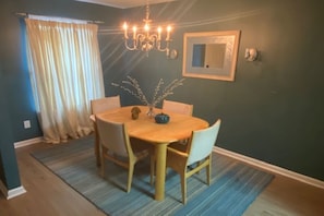 Elegant Dining Room with new flooring, designer rug and draperies!