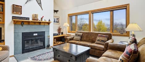 Tastefully decorated open space living room area.  Wood burning fireplace and great views during any season!