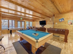 Game Room – Full-size pool table, foosball, air hockey, arcade machine and additional living room setup - Ground Floor