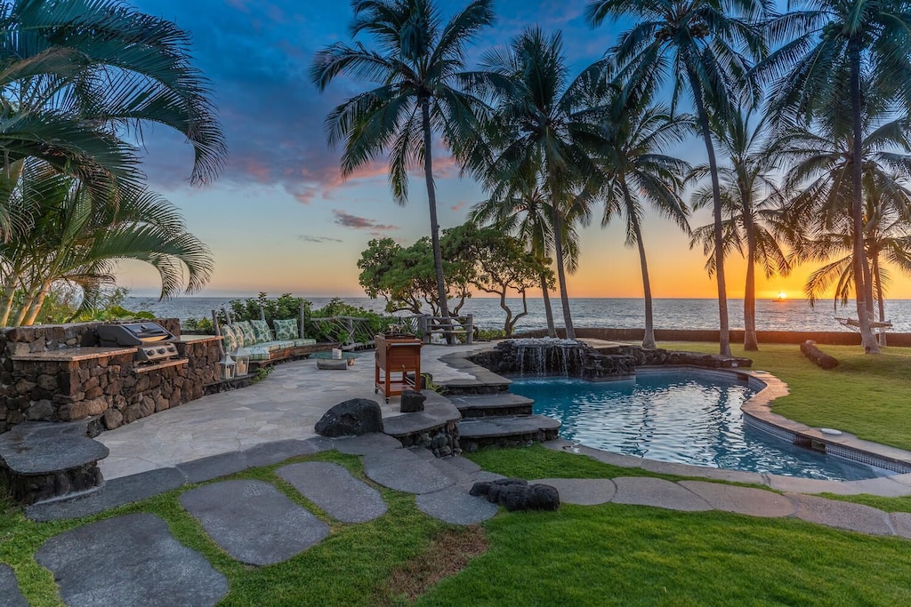 Image of a gorgeous Hawaiian sunset view of the pool area at this stunning villa in Hawaii. 