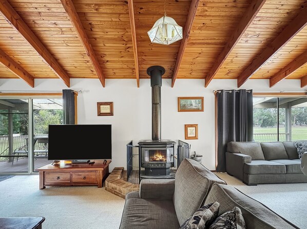 Enjoy the cozy living area with a wood fire, ideal for both warmth and ambiance. Complete with Smar