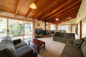 Enjoy the cozy living area with a wood fire, ideal for both warmth and ambiance.