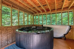 Hot tub in screened in porch for year round use even during a rainy night.