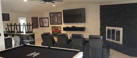 Theater room with pool table and bar 