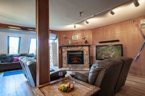 Living room with an electric fireplace.