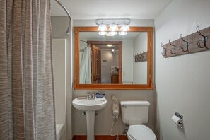 Full bathroom located in hallway near the bedroom