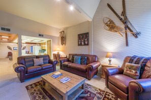 Main living room area, looking into the kitchen and dining room in the background.