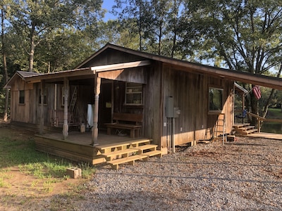 Cabin with 40 ft porch overlooking a pond. 