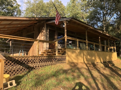 Cabin with 40 ft porch overlooking a pond. 